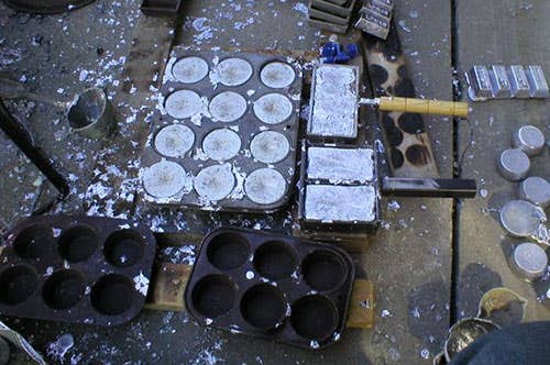 Metals inside molds on a warehouse floor