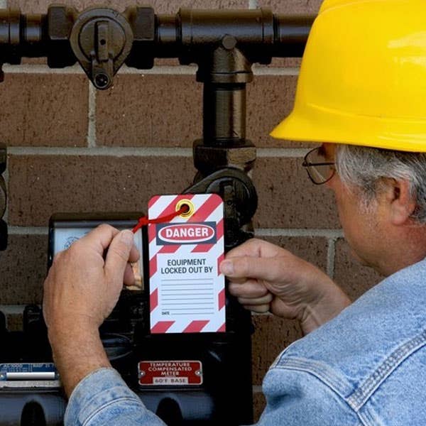 Image ofman looking at lockout/tagout tag